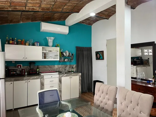 Kitchen with A/C unit and vaulted ceiling